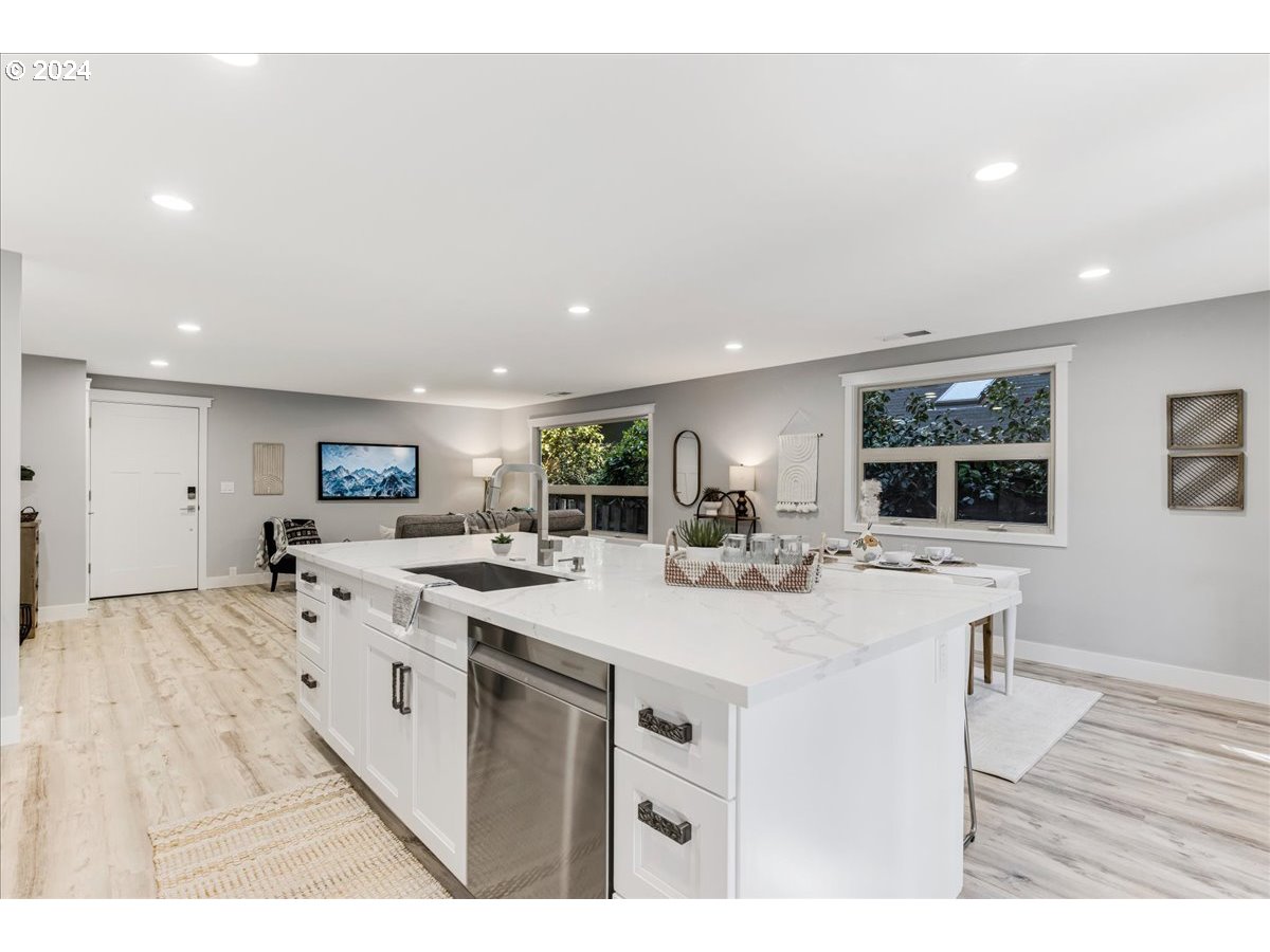4820 Southwest Marigold Street Portland, OR 97219 - Photo 6 of 34 a kitchen with stainless steel appliances a sink stove and cabinets