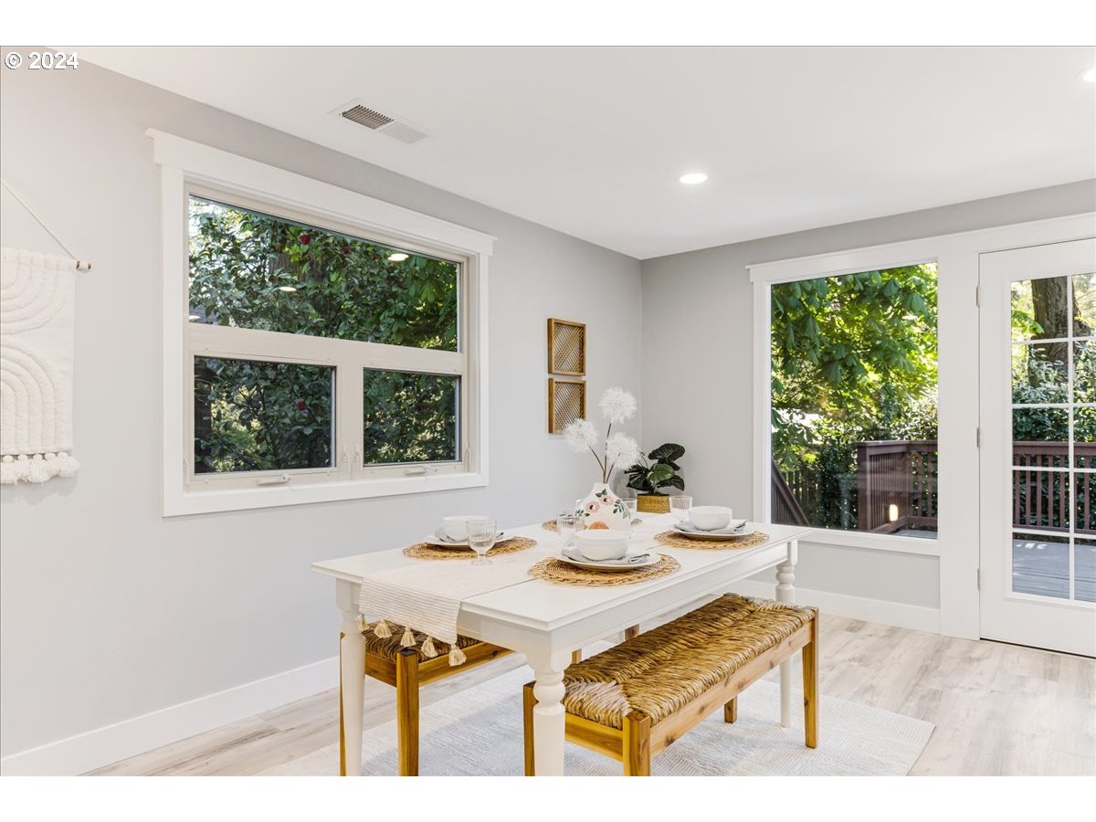 4820 Southwest Marigold Street Portland, OR 97219 - Photo 9 of 34 a dining room with a table and chairs