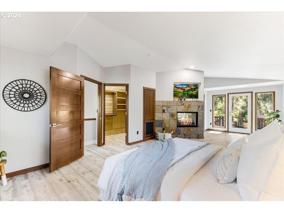 4820 Southwest Marigold Street Portland, OR 97219 - Photo 10 of 34 a bed room with a bed furniture and a large window