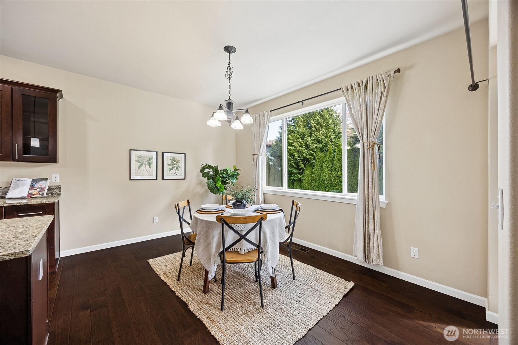 4703 Prestwick Lane Southeast Lacey, WA 98513 - Photo 11 of 40 a dining room with furniture a chandelier and wooden floor