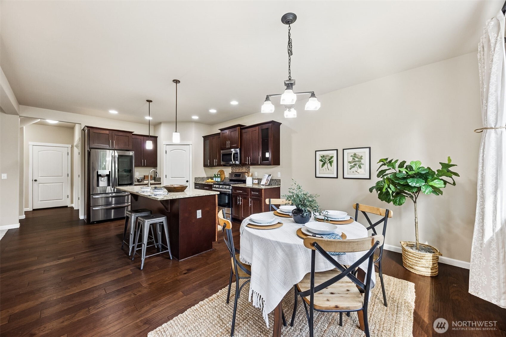 4703 Prestwick Lane Southeast Lacey, WA 98513 - Photo 12 of 40 a dining room with furniture a chandelier and kitchen view