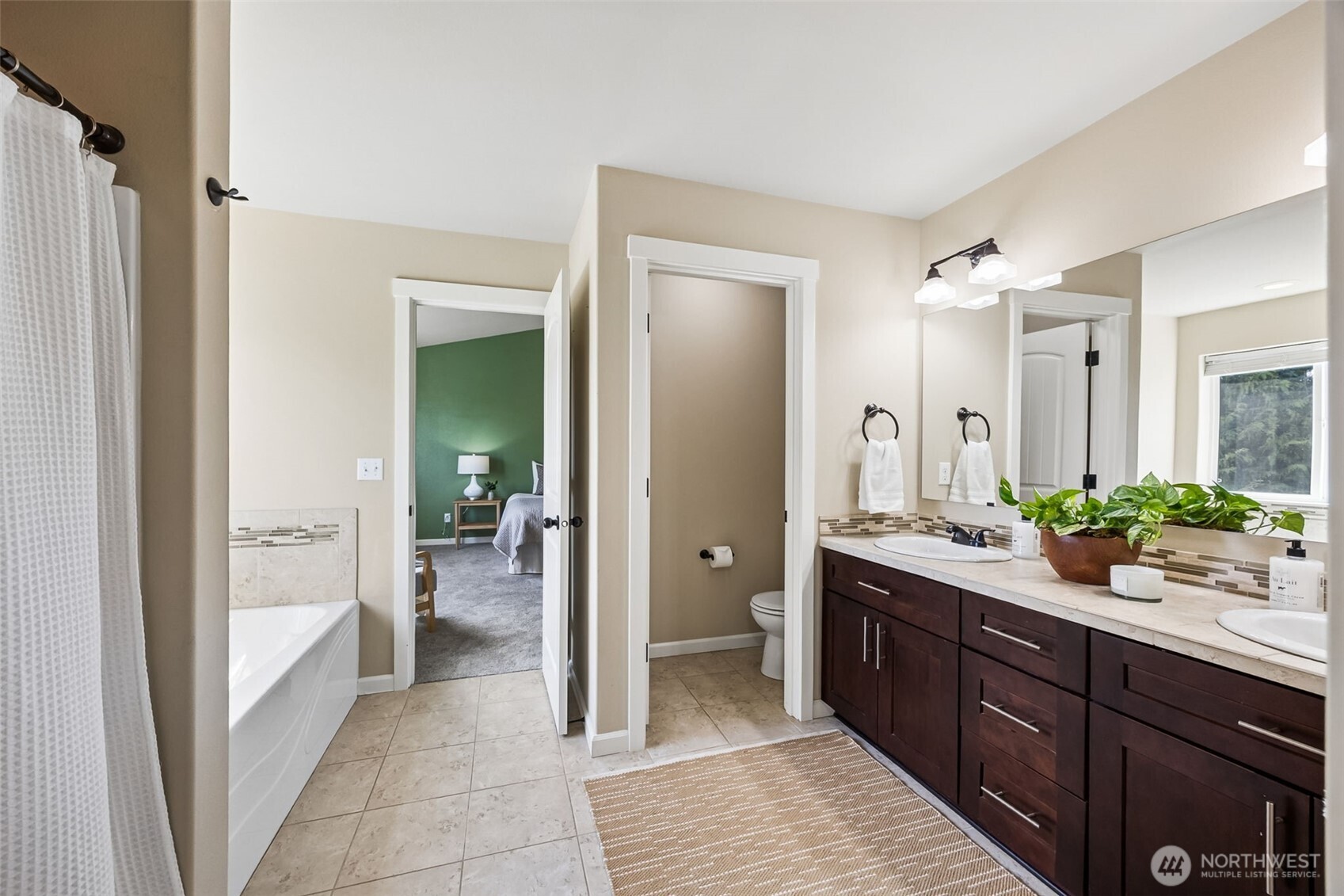 4703 Prestwick Lane Southeast Lacey, WA 98513 - Photo 23 of 40 a spacious bathroom with a shower sink and mirror