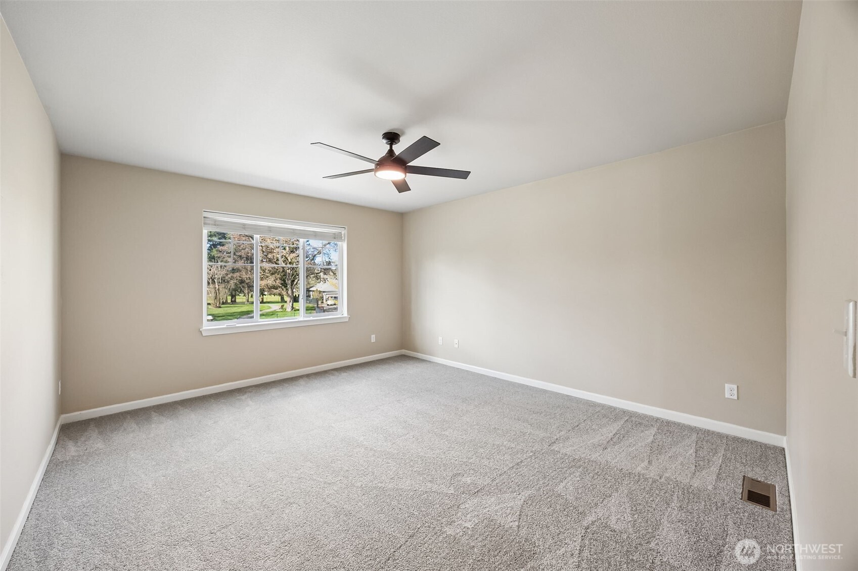 4703 Prestwick Lane Southeast Lacey, WA 98513 - Photo 28 of 40 an empty room with windows and chandelier fan