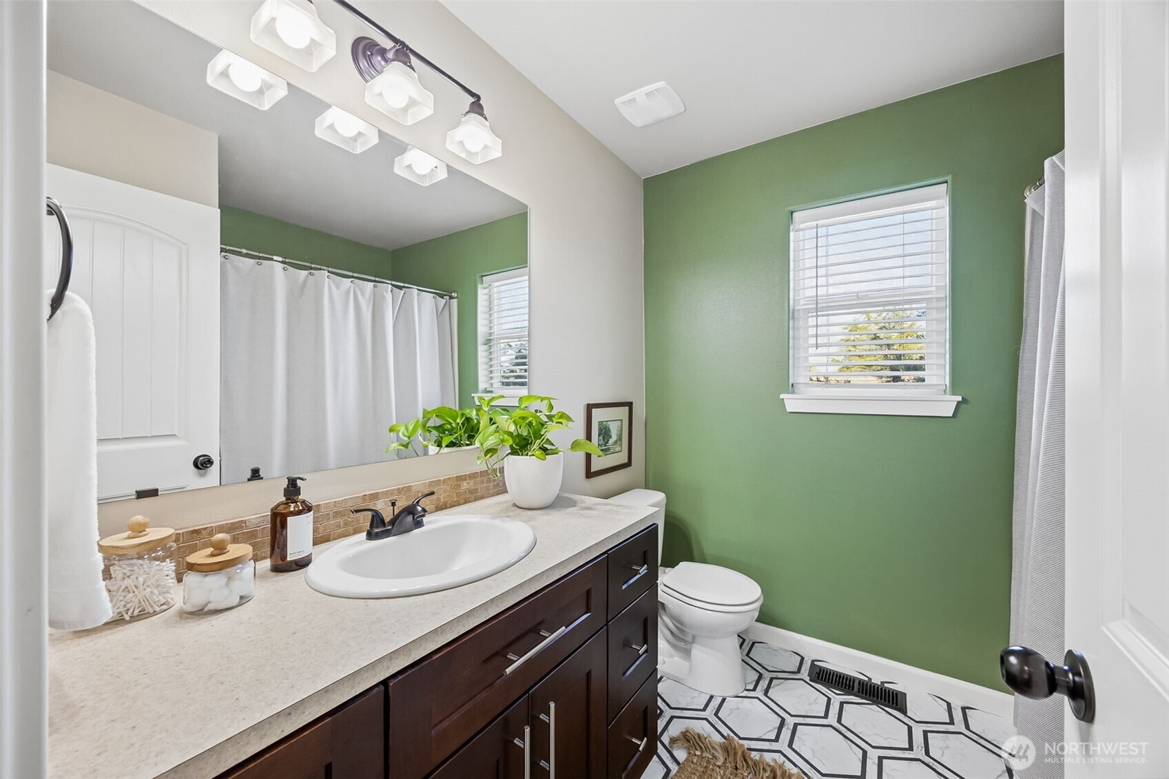 4703 Prestwick Lane Southeast Lacey, WA 98513 - Photo 29 of 40 a bathroom with a granite countertop sink a toilet and a mirror