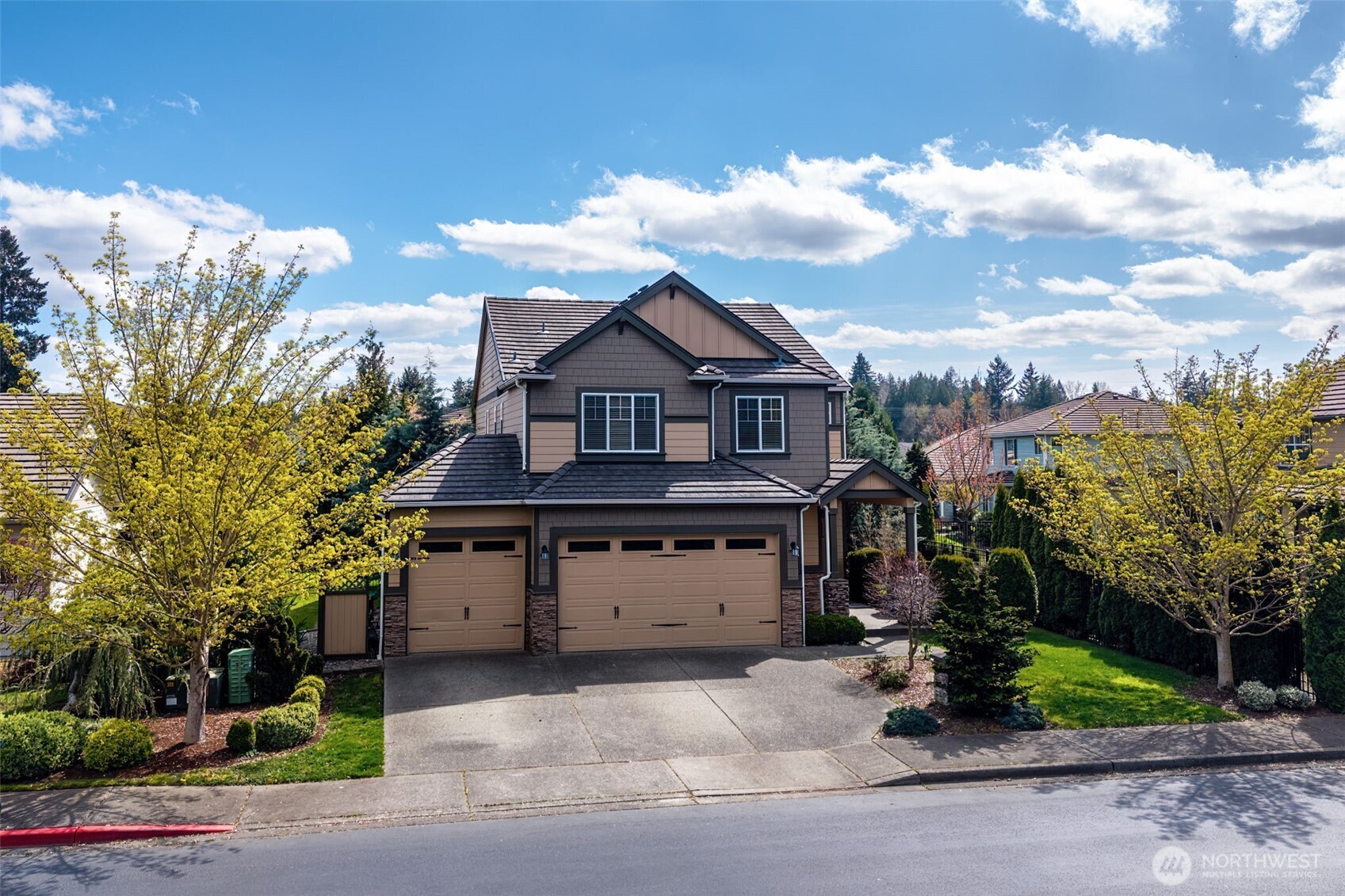 4703 Prestwick Lane Southeast Lacey, WA 98513 - Photo 4 of 40 a front view of a house with a garden and trees