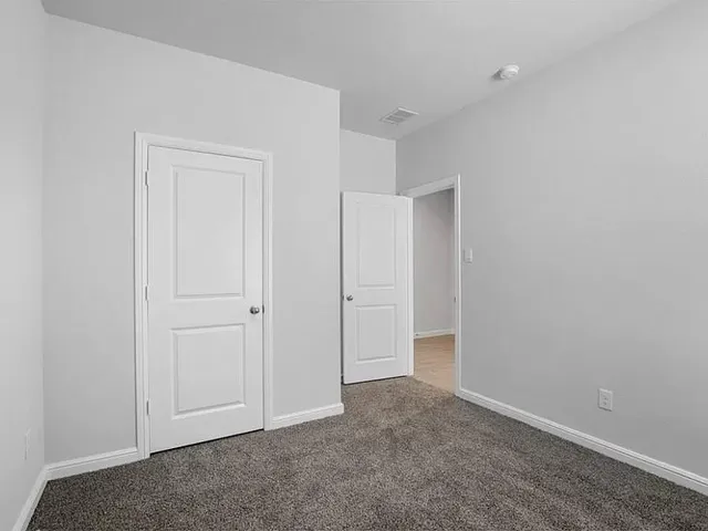 an empty room with closet area