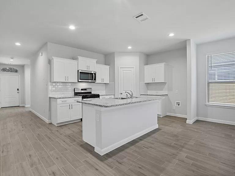 5229 Boulder Vly Drive Fort Worth, TX 76179 - Photo 2 of 39 a kitchen with granite countertop a refrigerator stove top oven and sink