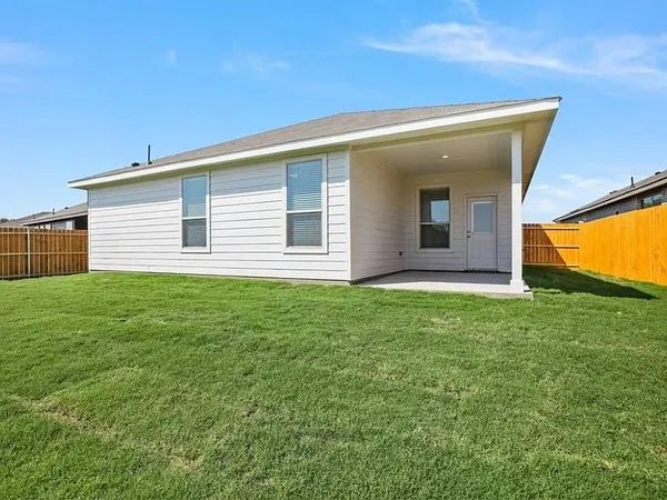 a view of a house with a backyard