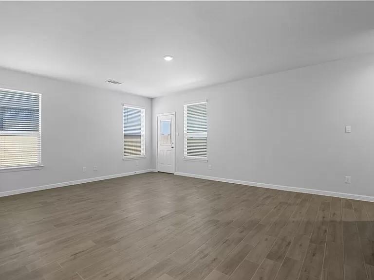 5229 Boulder Vly Drive Fort Worth, TX 76179 - Photo 10 of 39 an empty room with wooden floor and windows