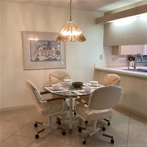 a dining room with furniture and chandelier