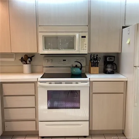 a kitchen with a sink cabinets and appliances