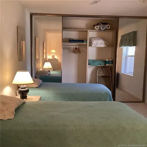 a bedroom with a bed and a mirror