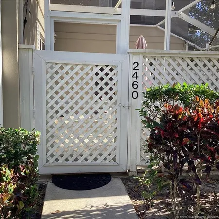 a view of a patio with table and chairs with wooden fence