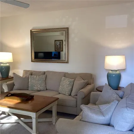 a living room with furniture a window and a flat screen tv