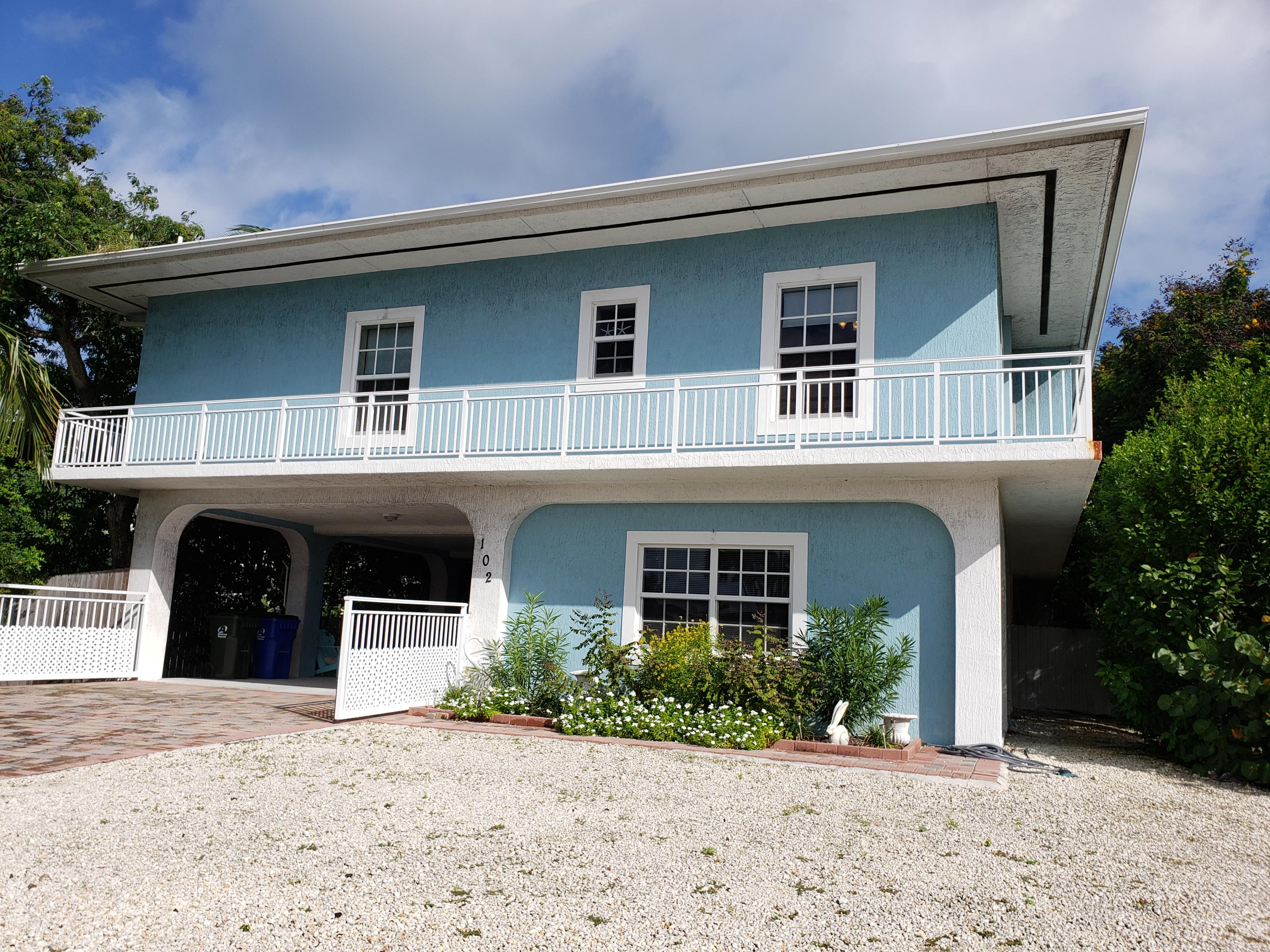 a front view of a house with a yard and a garage