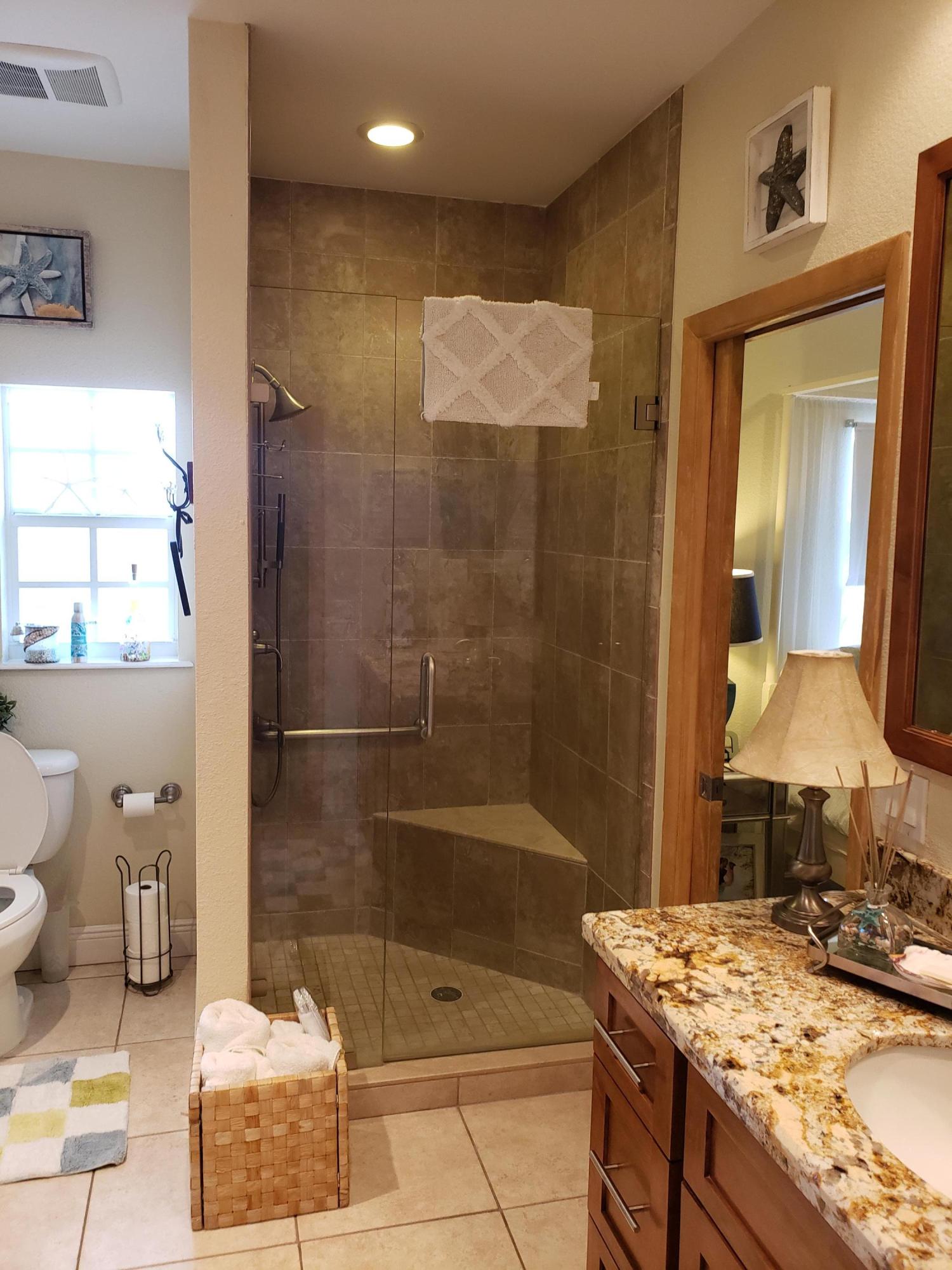 102 Mockingbird Road Tavernier, FL 33070 - Photo 5 of 17 a bathroom with a granite countertop sink a toilet and shower