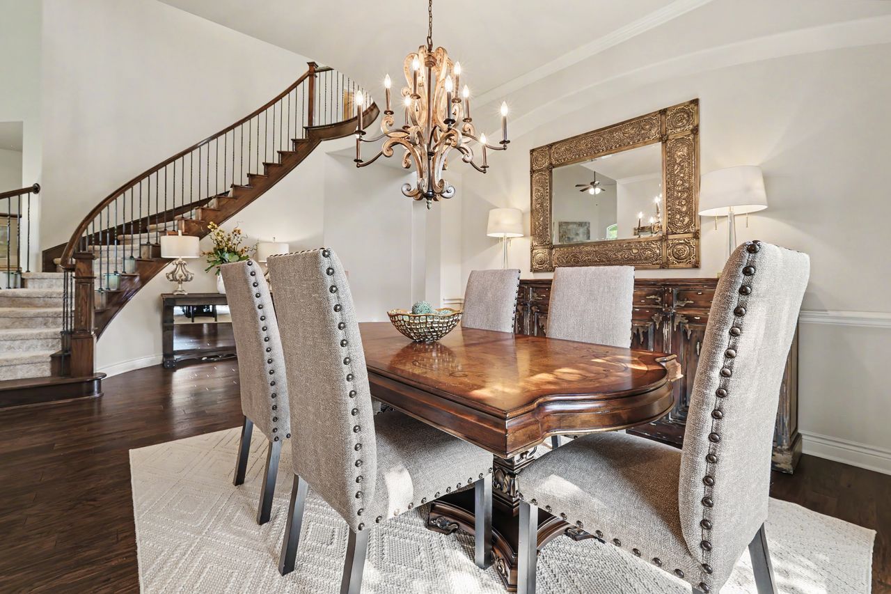 809 Prairie Dunes Drive Georgetown, TX 78628 - Photo 6 of 40 A graceful curved staircase and rich hardwood floors create a grand entry to this elegant dining space.