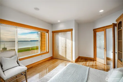 a bedroom with a bed and a large window