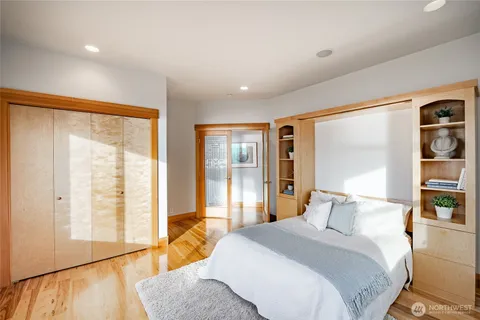 a bedroom with a large bed and a large window