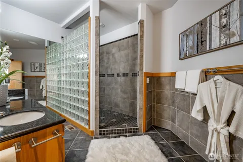 a bathroom with a shower and a sink