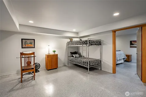 a bedroom with furniture and a chair