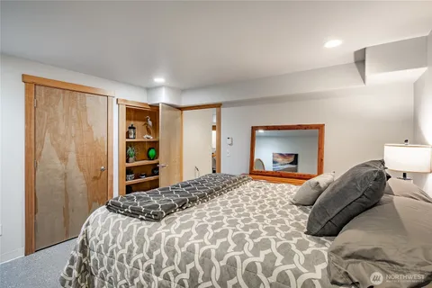 a bedroom with a bed and a closet