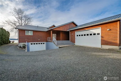 a view of a house with a yard and garage