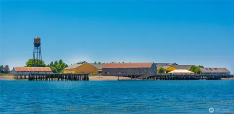a front view of a house with a yard and lake view