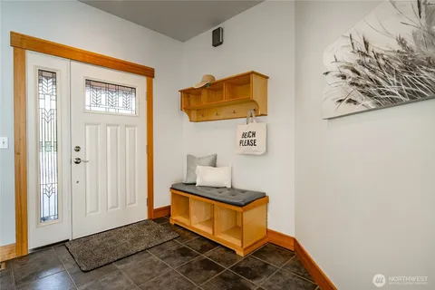 a bedroom with a bed and painting on the wall