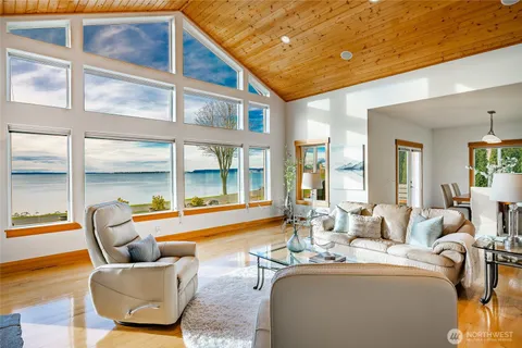 a living room with furniture and floor to ceiling windows
