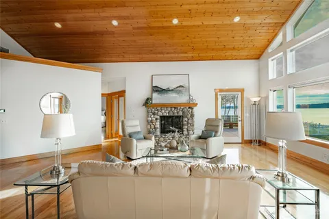 a living room with fireplace furniture and a lamp