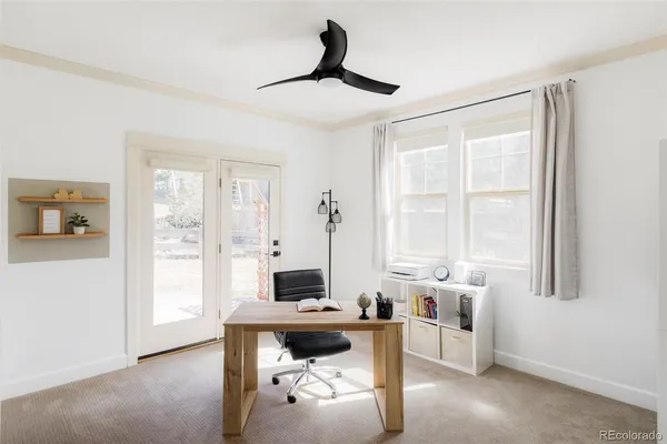 a view of a livingroom with workspace and a window