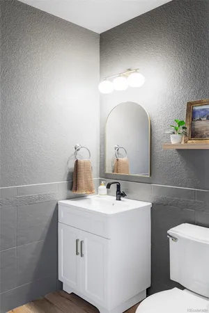 a bathroom with a sink toilet and a mirror
