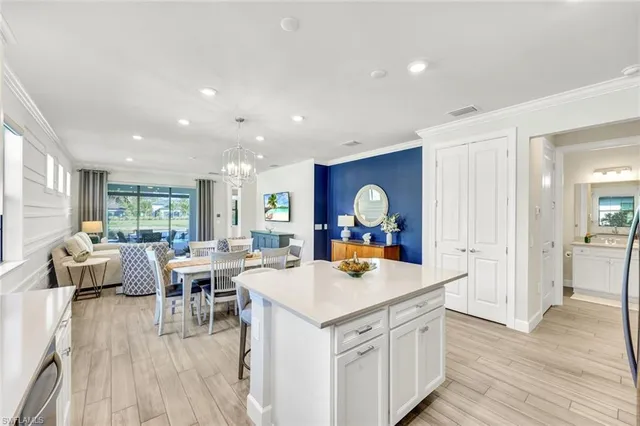 a view of a kitchen area with furniture and wooden floor