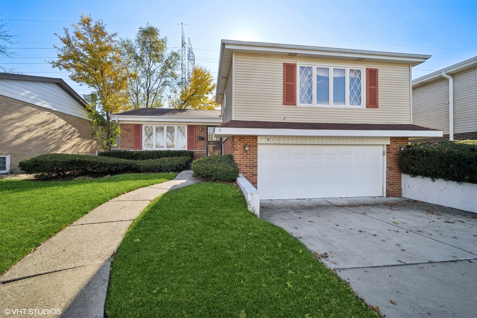a front view of a house with a yard and garage