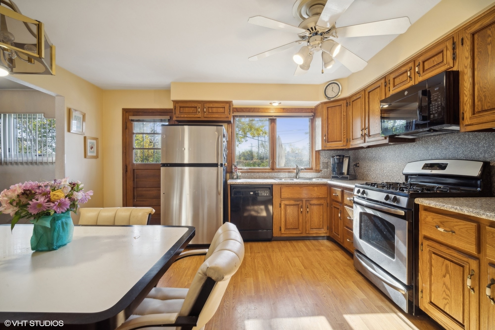 7933 Beckwith Road Morton Grove, IL 60053 - Photo 12 of 32 a kitchen with stainless steel appliances granite countertop a refrigerator a stove top oven a sink dishwasher and white cabinets with wooden floor
