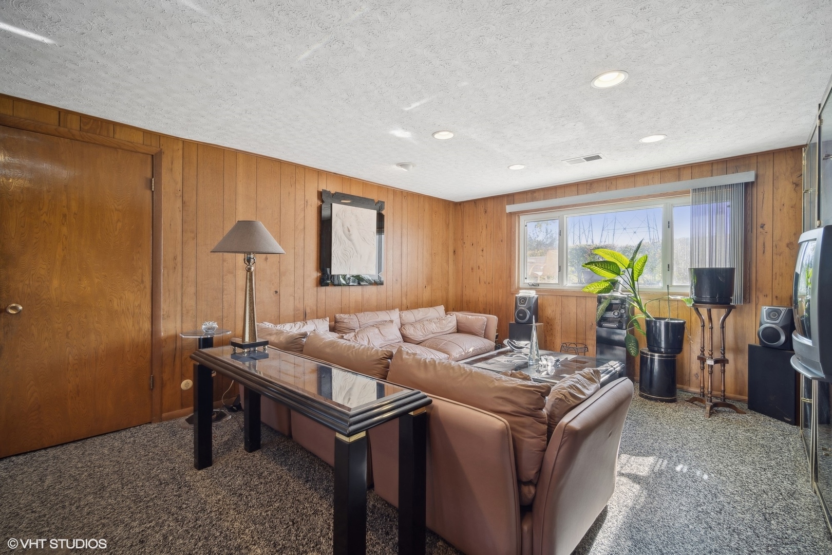 7933 Beckwith Road Morton Grove, IL 60053 - Photo 16 of 32 a living room with furniture a lamp and a potted plant
