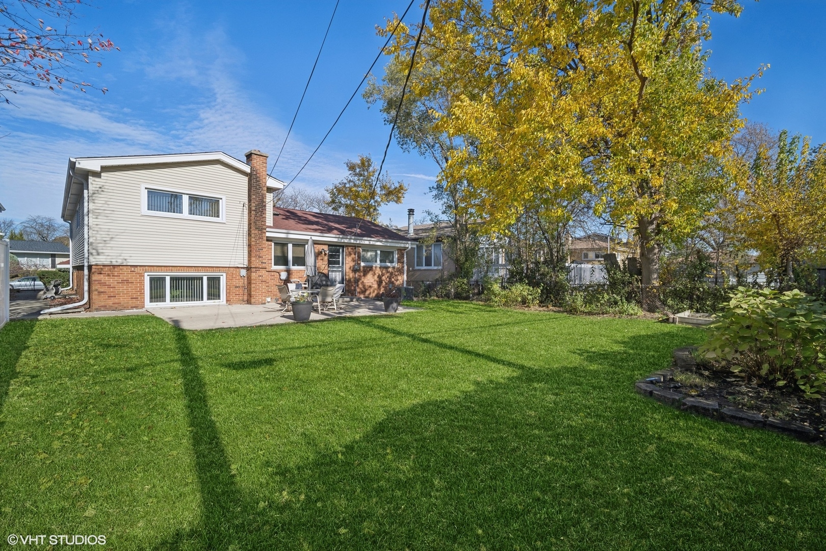 7933 Beckwith Road Morton Grove, IL 60053 - Photo 24 of 32 a view of a house with a big yard and large trees