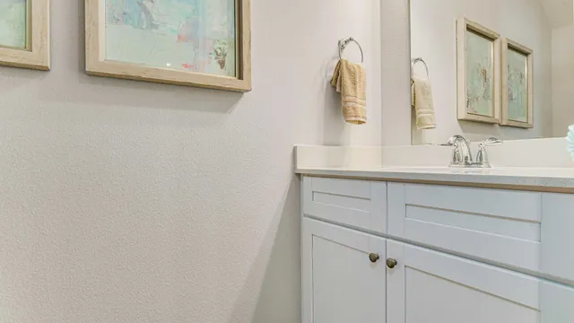 a bathroom with a sink vanity and mirror