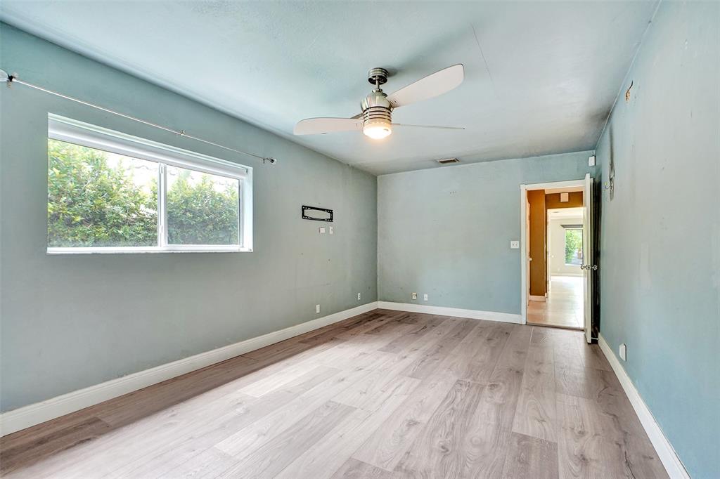 1626 Tyler Street Hollywood, FL 33020 - Photo 14 of 28 a view of an empty room with wooden floor and a window