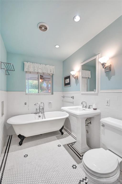 1626 Tyler Street Hollywood, FL 33020 - Photo 17 of 28 a bathroom with a sink a toilet and mirror