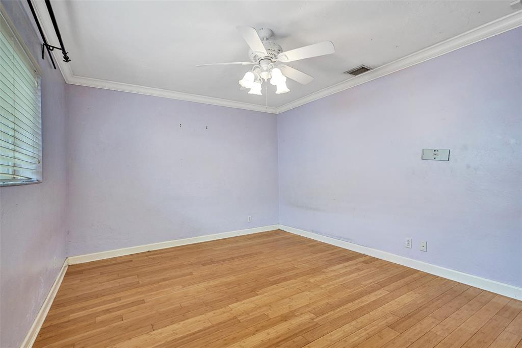 1626 Tyler Street Hollywood, FL 33020 - Photo 20 of 28 an empty room with wooden floor and fan