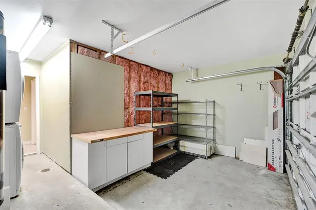 a view of a house with a small yard and wooden fence