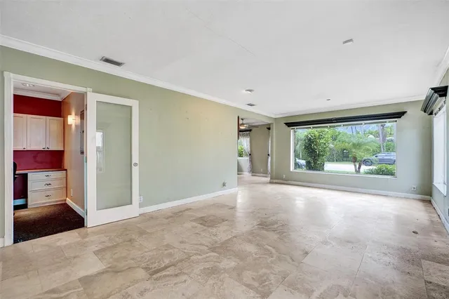 an empty room with windows and view of an empty room