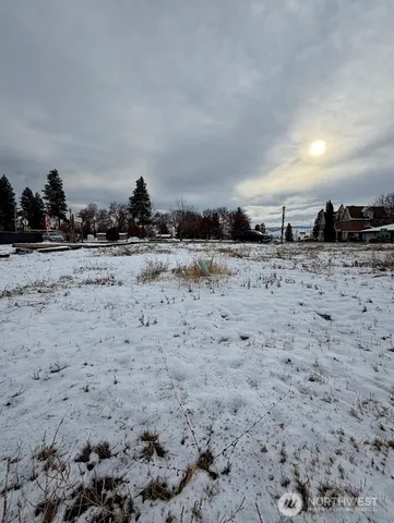 a view of dirt road and covered with snow