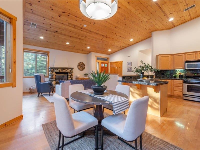 12678 Hidden Circle, Unit 4 Truckee, CA 96161 - Photo 14 of 28 a dining room with furniture a rug kitchen view and a large window