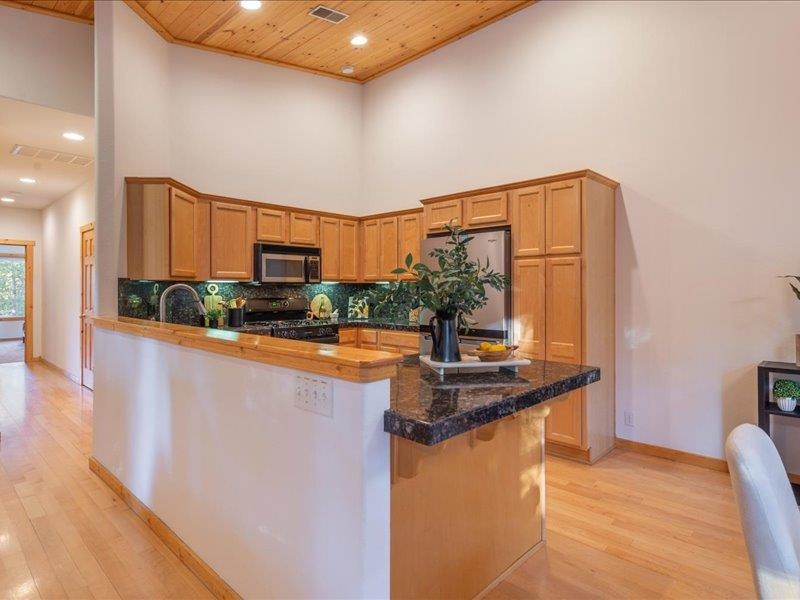 12678 Hidden Circle, Unit 4 Truckee, CA 96161 - Photo 15 of 28 a kitchen with stainless steel appliances granite countertop a sink and a stove top oven
