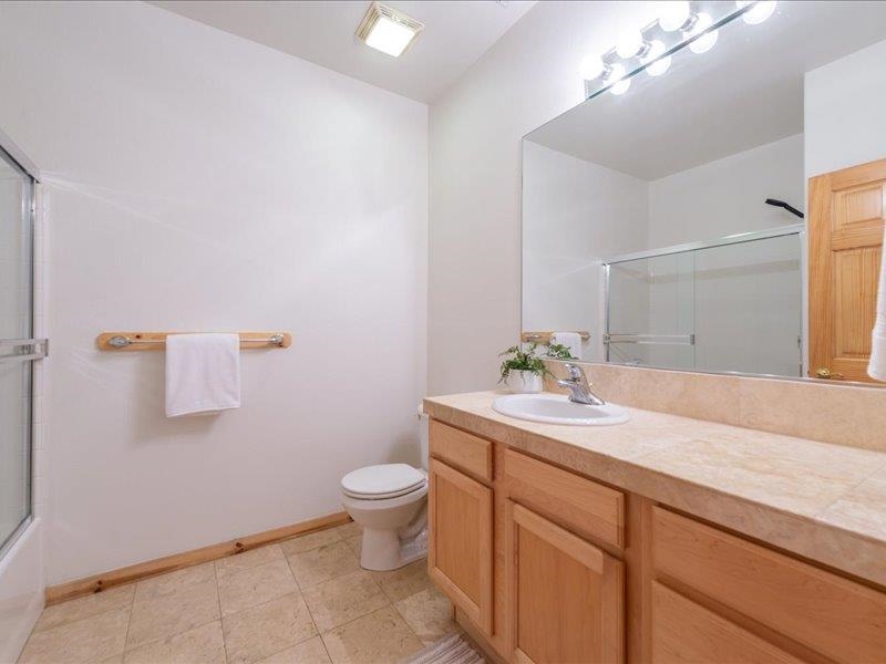12678 Hidden Circle, Unit 4 Truckee, CA 96161 - Photo 23 of 28 a bathroom with a granite countertop sink a toilet and mirror