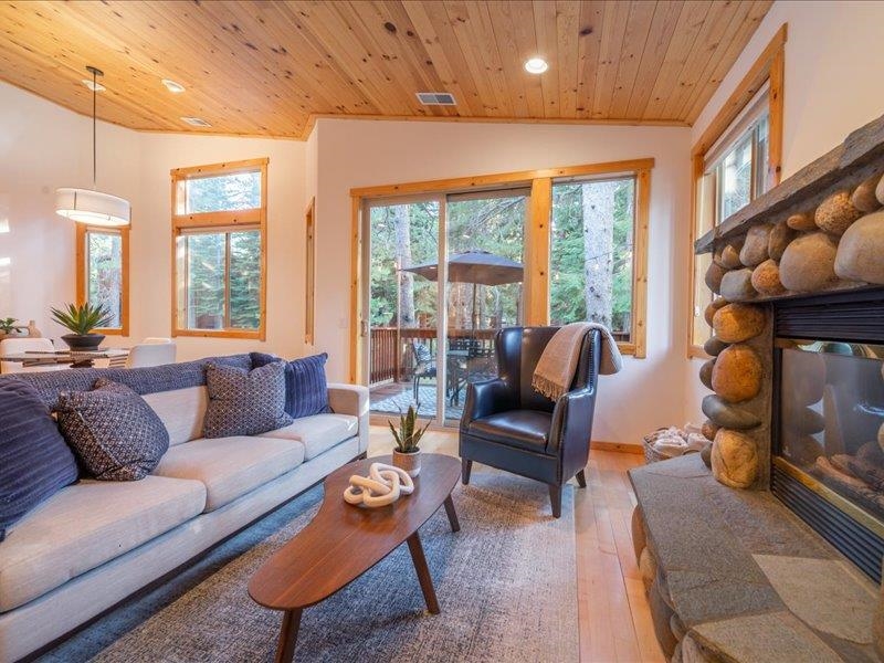 12678 Hidden Circle, Unit 4 Truckee, CA 96161 - Photo 10 of 28 a living room with furniture a fireplace and a large window
