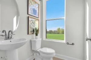 a bathroom with a toilet a sink and a large mirror